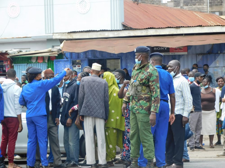 Police officers try to control Jamhuri High School parents outside the institution on November 15, 2021.