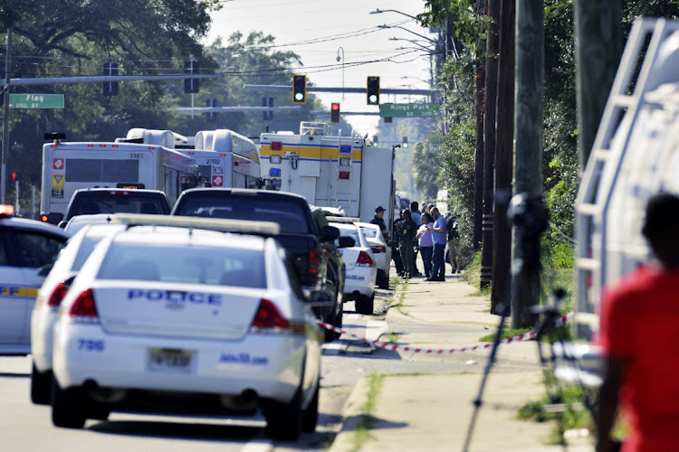 Emergency personnel surround a Dollar General store after a white man armed with a high-powered rifle and a handgun killed three Black people before shooting himself, in what local law enforcement described as a racially motivated crime in Jacksonville, Florida, US August 26, 2023.