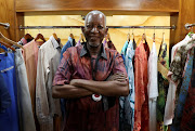 Burkinabe-Ivorian stylist Pathe Ouedraogo, known as Pathe'O, smiles as he poses in one of his shops, ahead of the fashion show marking the 50 years of his career and the inauguration of 