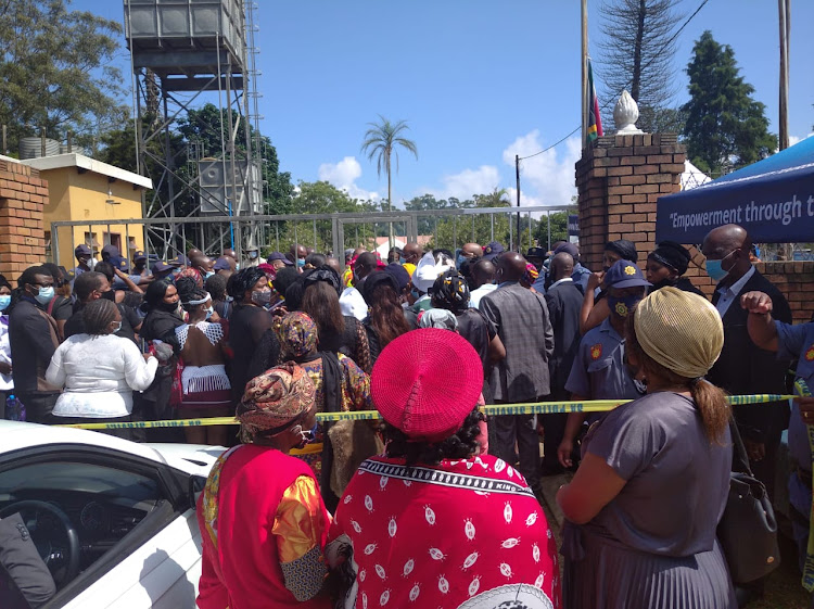Dozens of people outside the gates of the royal palace in Nongoma where the memorial service of late Zulu monarch King Goodwill Zwelithni was hosted