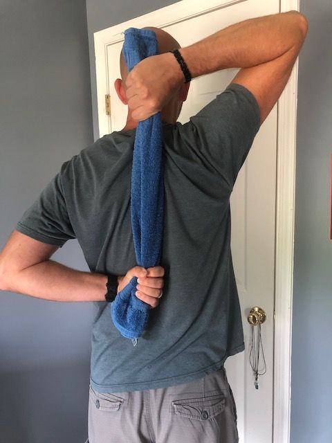 A rolled towel, blanket, rope, or long belt is a great yoga prop alternative to yoga straps!