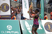 Bongumusa Mthembu celebrates at the finish line at the Moses Mabhida Stadium in Durban after winning the 2018 Comrades Marathon.