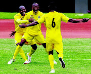 FAMILIAR SIGHT: PSL Footballer of the Season Khama Billiat, centre,  celebrates his goal with  former-Kaizer Chiefs striker Knowledge Musona as Zimbabwe beat Malawi 3-0  
        PHOTO: JEKESAI NJIKIZANA/AFP