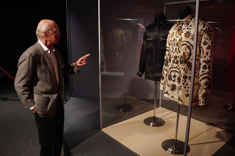 Arlan Ettinger, president of Guernsey's auctions, talks as he points to shirts formerly belonging to Nelson Mandela that are going up for auction in New York to raise funds for charity.