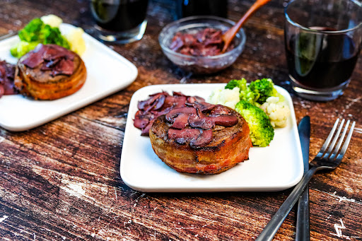 Bacon-Wrapped Filet With Sauteed Mushrooms on a plate.