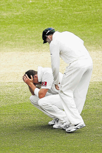 Peter Siddle, on his haunches, head in hands, epitomises his exhaustion and frustration felt by Australia at the Adelaide result Picture: MORNE DE KLERK/GALLO IMAGES