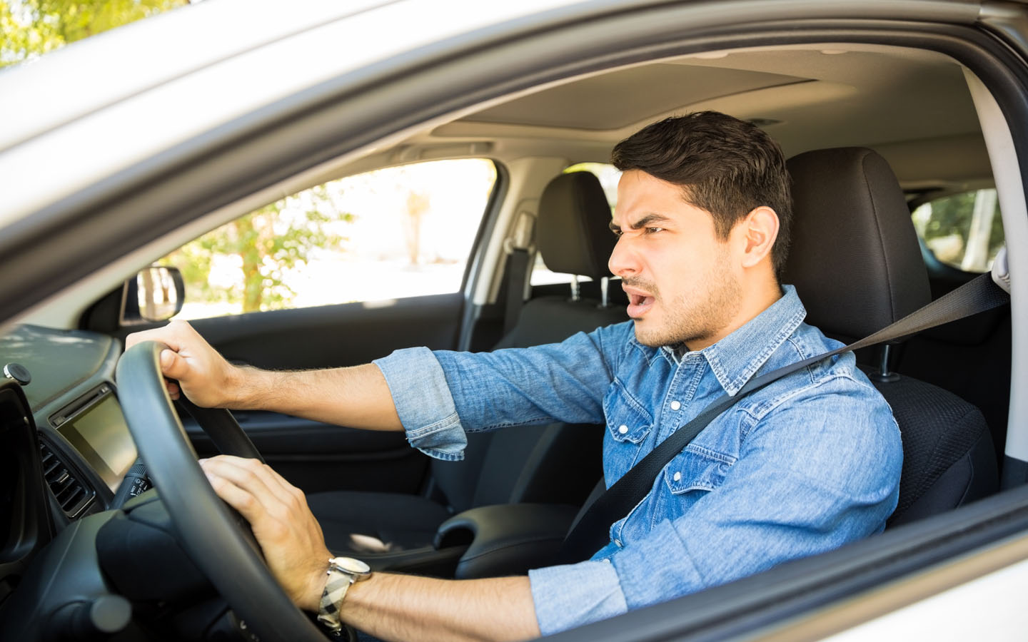 frustrated man pressing car horn