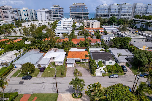 Residential neighborhood with houses and buildings in this luxury house for rent in Surfside ($11,000)
