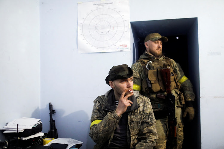 A Ukrainian serviceman smokes inside a basement used as a command post in Ruska Lozova, a village retaken by the Ukrainian forces, amid Russia’s attack on Ukraine, in Kharkiv region, Ukraine, on May 15 2022. Picture: REUTERS/RICARDO MORAES