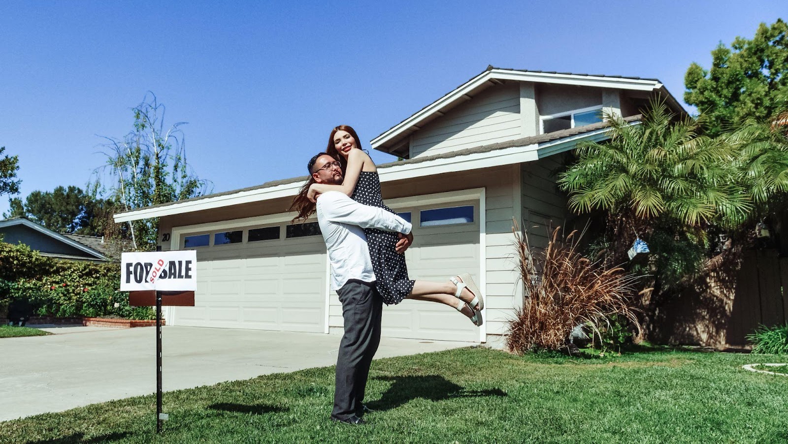 a couple in front of their new home