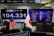 Monitors show the Japanese yen exchange rate against the US dollar and news on Democratic US presidential nominee Joe Biden at a dealing room of the foreign exchange trading company Gaitame.com in Tokyo, Japan November 5, 2020. 
