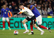 Germany's Kai Havertz shields the ball from France's Aurelien Tchouameni in the international friendly at Groupama Stadium in Lyon, France on Saturday.