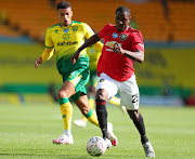 Ben Godfrey of Norwich City battles for possession with Odion Ighalo of Manchester United during the FA Cup Quarter Final match between Norwich City and Manchester United at Carrow Road on June 27, 2020 in Norwich, England. 