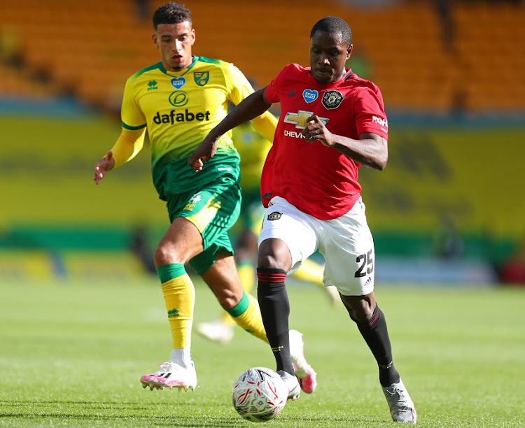 Ben Godfrey of Norwich City battles for possession with Odion Ighalo of Manchester United during the FA Cup Quarter Final match between Norwich City and Manchester United at Carrow Road on June 27, 2020 in Norwich, England.