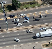 The crime scene on the M1 highway near the Woodmead exit in Johannesburg on Monday after a shoot-out between law enforcement and a gang of armed robbers. 