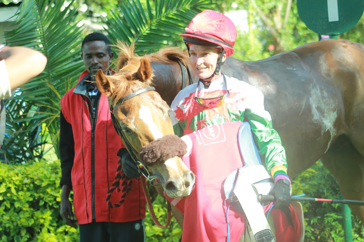 Jockey Leslie Sercombe after disembarking Gold Pot with his handler on January 12 at Ngong Race Course, Nairobi.