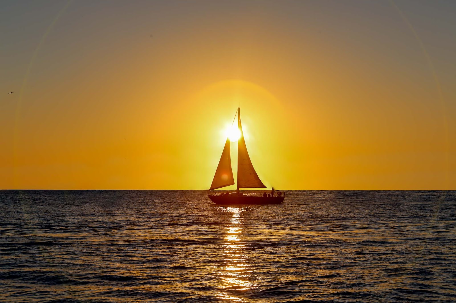 A sunset with a boat enhancing the shot.