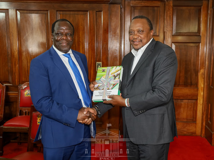 President Uhuru Kenyatta receives the Sugar Taskforce Report from Governor Wycliffe Oparanya who co-chaired the initiative with Agriculture CS Peter Munya at Stete House on February 24, 2020