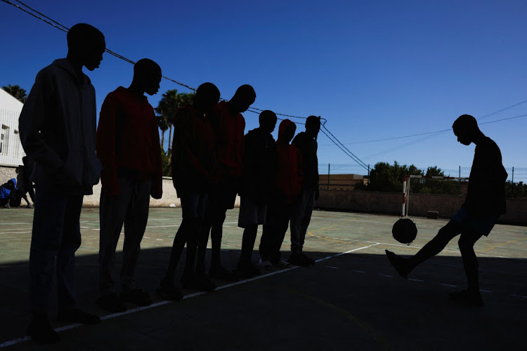 Several migrants minors play ball in the playground of the residence where they live in Valverde, Spain, November 7, 2023. REUTERS/BORJA SUAREZ