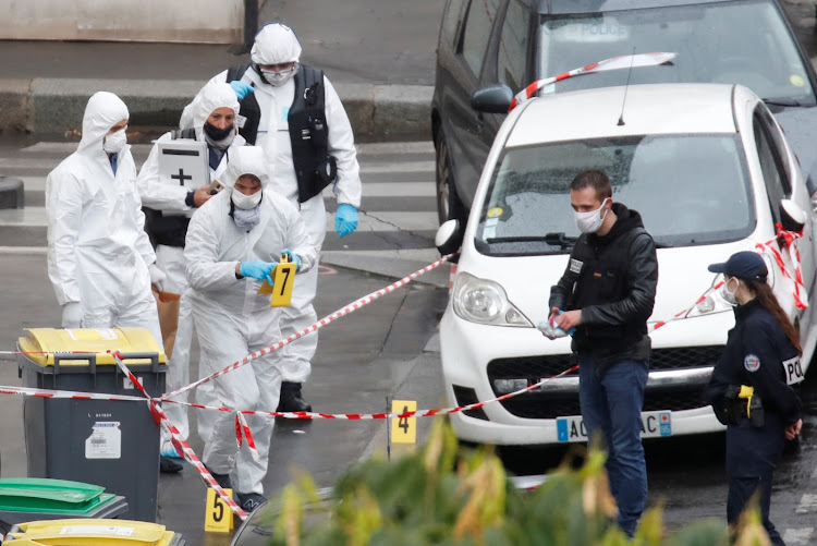 Forensic experts work at the scene of a stabbing attack near the former offices of French magazine Charlie Hebdo, in Paris, France September 25 2020.