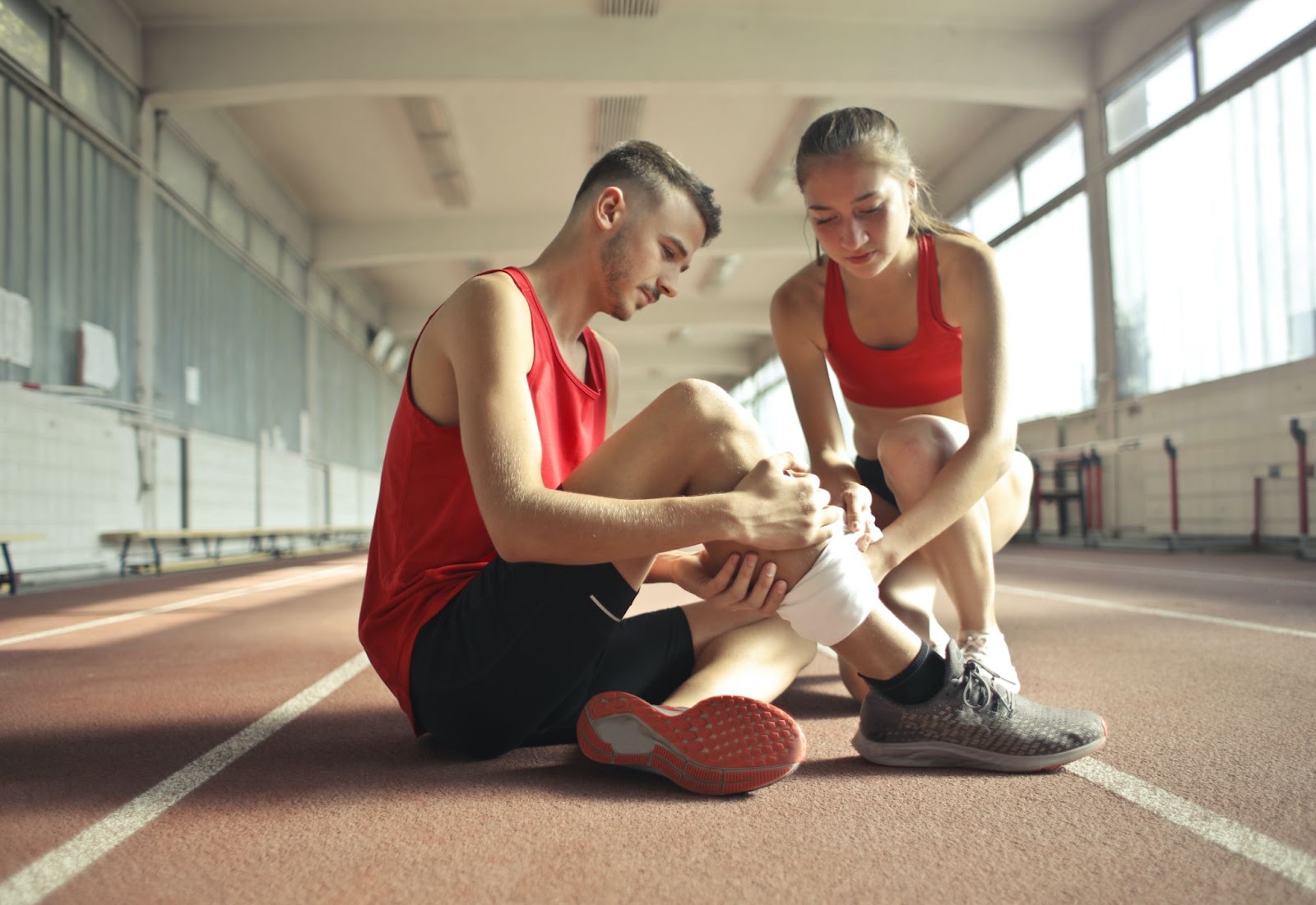 Couple treating a leg injury, fitness, exercise, running, injured, recovery, rest