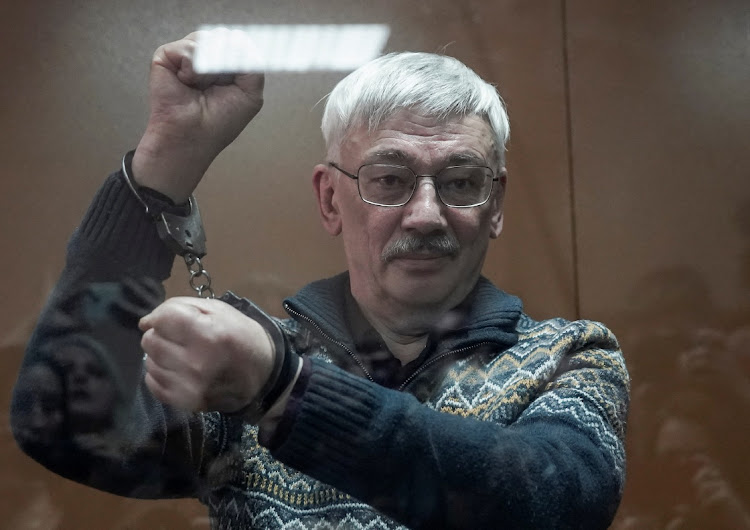 Russian veteran human rights campaigner Oleg Orlov gestures in handcuffs while standing behind a glass wall of an enclosure for defendants as he attends a court hearing in Moscow, Russia, on February 27 2024. Picture: TATYANA MAKEYEVA/REUTERS