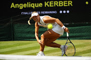 Angelique Kerber of Germany returns against Jelena Ostapenko of Latvia during their Ladies' Singles semi-final match on day ten of the Wimbledon Lawn Tennis Championships at All England Lawn Tennis and Croquet Club on July 12, 2018 in London, England. 