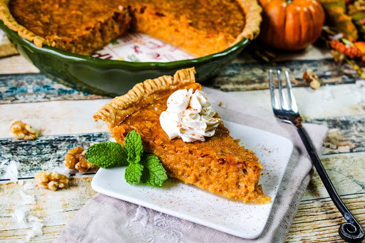 Slice of Coco Nutty Pumpkin Pie with whipped cream.