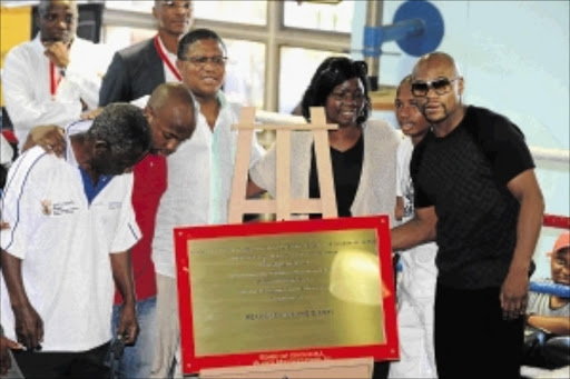 REAWAKENING A GIANT: Baby Jake Matlala's wife Mapula and sons Tshepo and Masego pose with Sports Minister Fikile Mbalula and Floyd Mayweather Jnr at Dube Boxing Gym last week Photo: Lefty Shivambu/Gallo Images