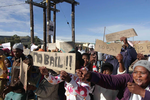 DISGRUNTLED: Residents of Cala picket outside the local magistrate’s court yesterday calling for no bail for the foreign national accused of murdering his South African girlfriend. Some in the crowd want all foreigners in the town to club together to bury the victim Picture: LULAMILE FENI