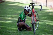 Similo Kheswa checks his bike during a training session. 