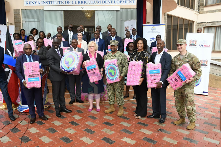 Education Principal Secretary Belio Kipsang and US Embassy Consular General Deborah Miller pose for a group photo with KICD directors during the handing over of sanitary towels donated to the ministry of education by US government (USAID KENYA EAST AFRICA) at the KICD on Wednesday 20, 2024