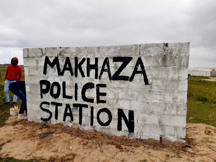 To mark five years since the Khayelitsha commission of inquiry recommended a police station be built in Makhaza, the Social Justice Coalition and residents built a wall on the building site. The station has yet to be built.