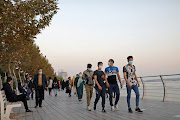 Iranian people wearing masks walk at a promenade, amid a rise in the coronavirus disease (Covid-19) infections, West Tehran, Iran October 23, 2020. File photo 