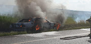 One of the cars was left burning after the cash heist. 