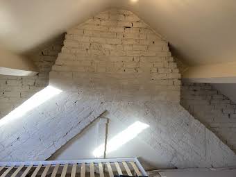 Boarding and plastering chimney stack in attic room album cover