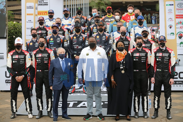 President Uhuru Kenyatta poses for a photo with the P1 drivers at KICC Nairobi during the launch of the FIA WRC, June 25 2021.