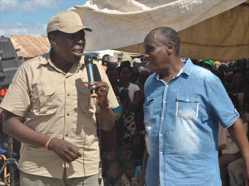 Devolution CS Eugene Wamalwa with Chief Administrative Secretary Hussein Dado at Garsen Primary School in Tana River County where relief food was distributed, February 27, 2018. /ALPHONCE GARI