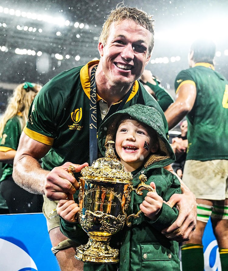 Pieter-Steph du Toit and his son, also Pieter-Steph, with the Webb Ellis Cup.