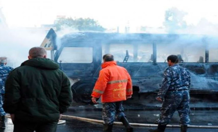 Two roadside bombs explode near military bus in Damascus, killing 13.