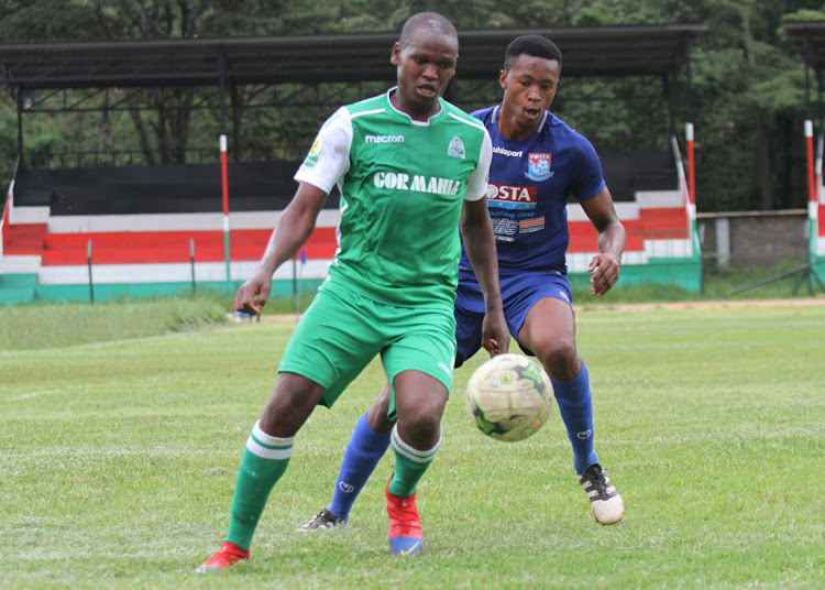 Gor Mahia's Nicholas Kipkirui vies for the ball with Dinkens Mwema of Posta Rangers