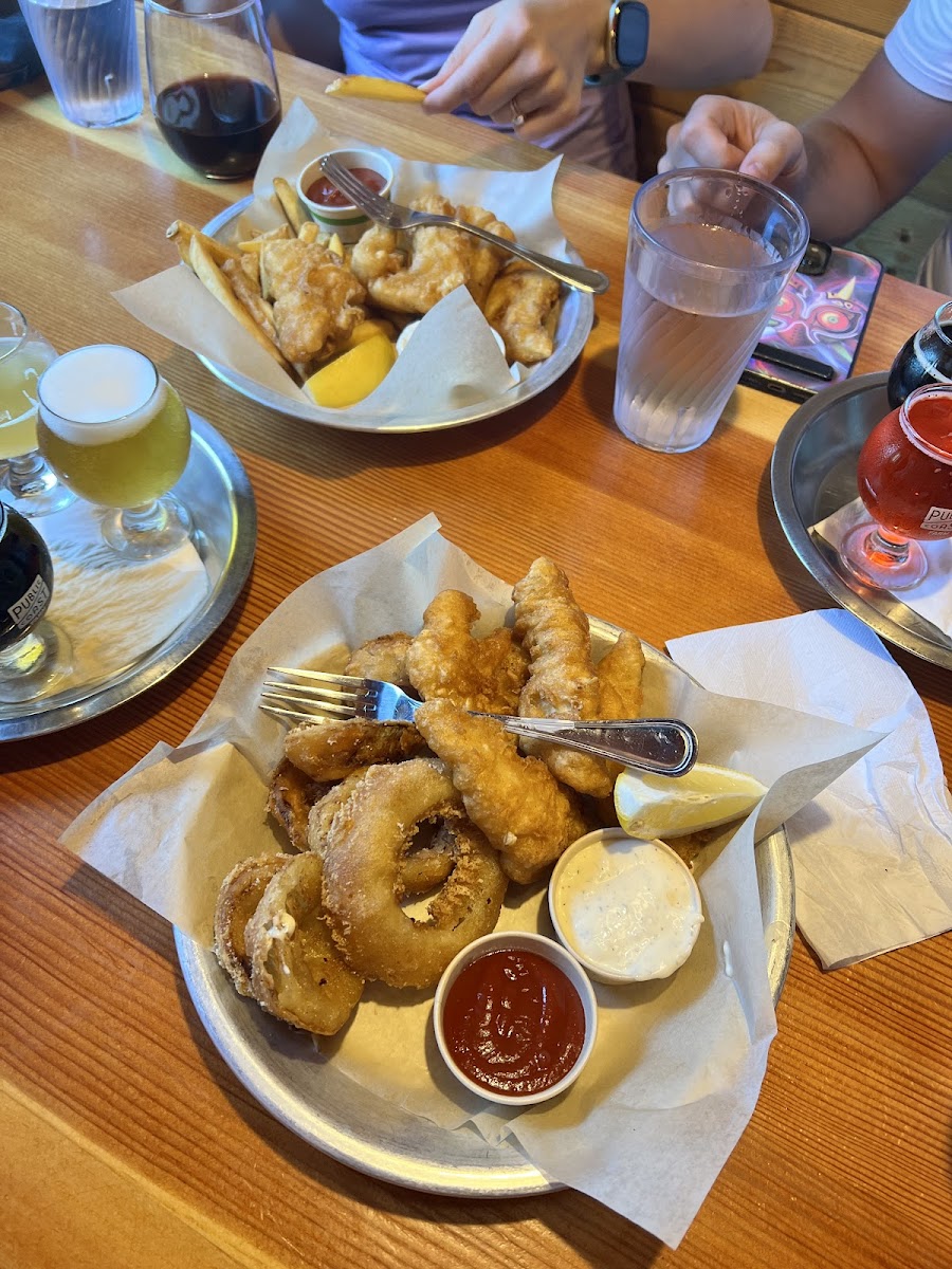 Cod fish and chips with onion rings and french fries