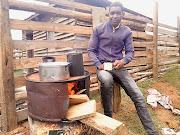 Avela Tshukutshela uses a brazier to cook food and boil water for the
family, including preparing formula milk for his baby. 