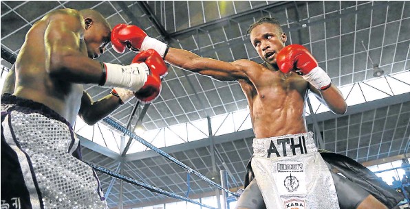 ON THE BUTTON: Athi Dumezweni leads with a straight left to the head of Lindile Tshemese during their title fight held in Mdantsane Sunday,