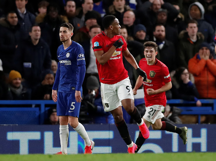 Anthony Martial celebrates scoring their first goal with Daniel James as Chelsea's Jorginho looks dejected.