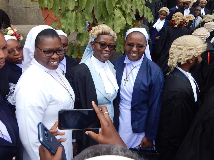 Sister Leonida Katunge poses with other nuns when she was admitted to the bar