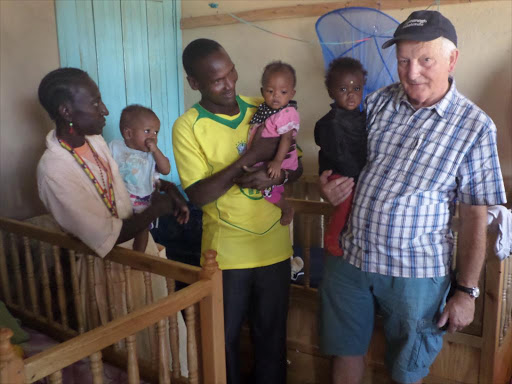 Ken Dobban, Nicholas Akoe and a caretaker of the toddlers with the three children rescued recently.