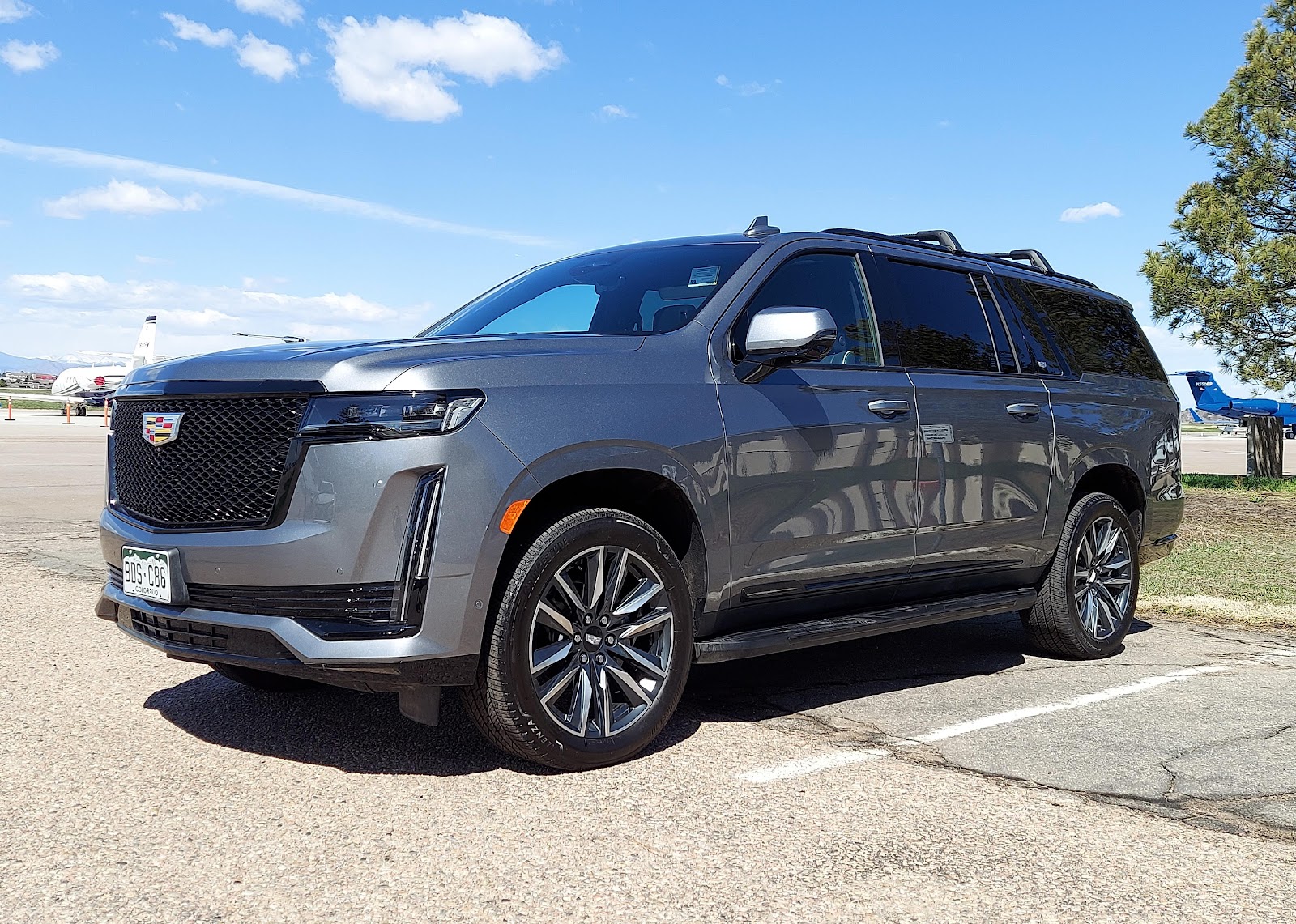 A dark gray Cadillac Escalade ESV outside.