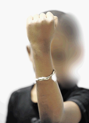 A pastor says the bracelet worn by a 9-year-old 'brings a belief in ancestors, contradictory to our belief in Jesus'.