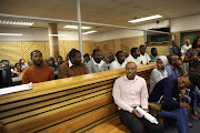 ANC councillor Nkosinathi Gambu (extreme left wearing an orange jersey) and his co-accused appeared in the PMB Regional court and six others on October 15 2018.